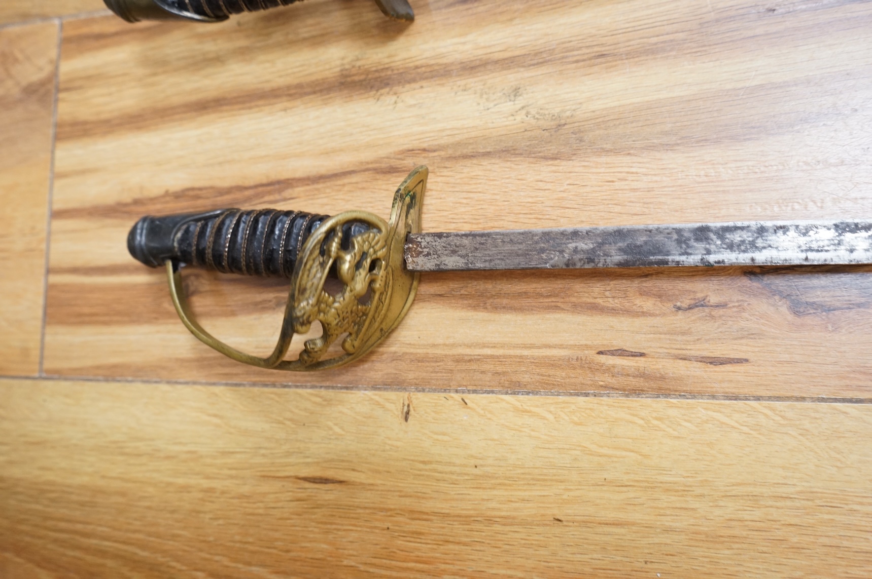 Two early 20th century Imperial German child’s swords with leather scabbards and hangers, blades 45.5cm